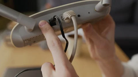 Female Hand Pressing Button on Wifi Router to Restart Internet Connection Stock Footage 332438162