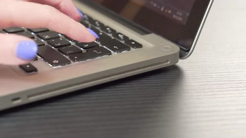 Female hand pressing enter button on a laptop. Close up. Stock Footage 165154351