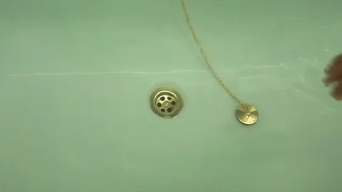 Female hand pull off chain with bath tub drain stopper from bath 스톡 동영상 80007374