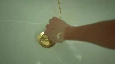 Female hand pull off chain with bath tub drain stopper from bath  스톡 동영상 80007427