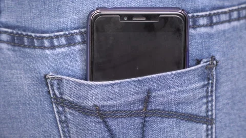 Female hand pull out black mobile phone of jeans pocket, rear back view 4k close Stock Footage 125815937