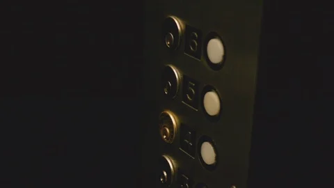 A female hand pushes a button in a dark elevator Stock Footage 126327805