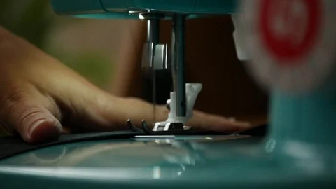 A female hand pushes material through a sewing machine Stock-Footage 112186176
