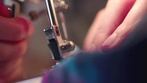 A female hand pushes material through a sewing machine. Stock Footage 269816111
