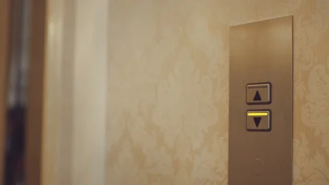 Female hand pushing button for calling elevator in apartment corridor Stock Footage 87621152
