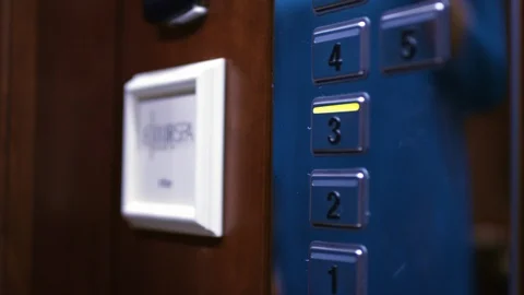 Female hand pushing third floor button on panel into elevator car Stock Footage 87661835