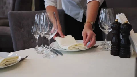 Female hand puts on cloth napkin on table before celebration at banquet hall. Video stock 213202353