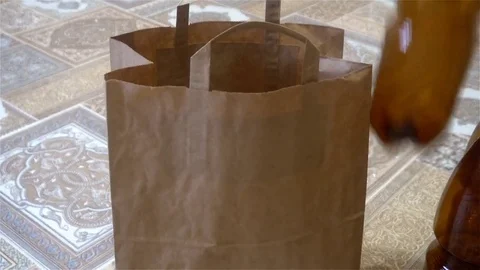 Female hand puts the empty plastic bottles in the package Stock Footage 83290340