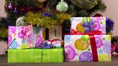 A female hand puts gift boxes under the Christmas tree.New year's night.Many Stock-Footage 165029797