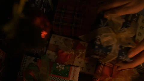 Female hand puts gift under christmas tree. Beautiful presents under the Stock Footage 145026147