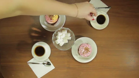 Female hand puts sugar cubes into cups of hot coffee Stock Footage 102128399
