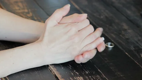 Female Hand Puts A Wedding Ring On The Table. Divorce Stock Footage 129294120