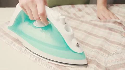 Female hand regulates the ironing temperature. Stock Footage 148199450