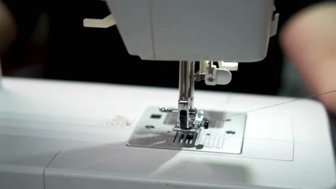 A female hand sets a spool of thread and closes the needle plate Video stock 170562191