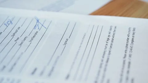Female hand signs a document, contract, agreement Stock Footage 169753559