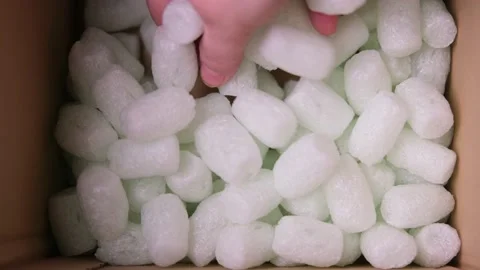Female hand is sorting polypropylene balls for packing fragile parcels in a c Video stock 149655179