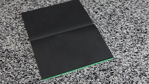 Female hand spelling PLAN on black paper laying table Stock Footage 89092012