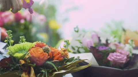 Female hand splattering flowers using a spray bottle close up. Hand with spray Stock Footage 99439766