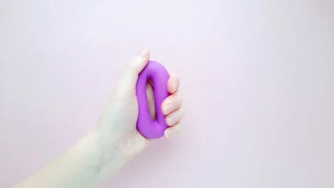 Female hand squeezes expander Stock Footage 166960631