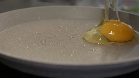 Female hand sscrambled eggs in a pan female hands Stock Footage 149305315