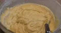 Female hand is stirring a yellow mixture/batter in a glass bowl HD Footage