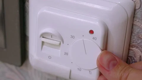Female hand switch on the control button choosing the right temperature Stock Footage 260412855
