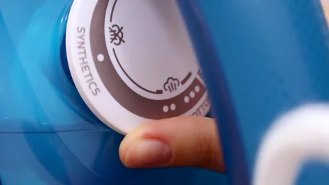 Female hand switch the control wheel with different ironing modes on the iron Video stock 264964353