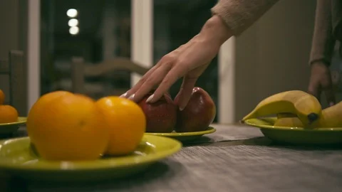 Female hand takes an apple from table Stock Footage 86559501