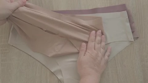 Female hand testing elasticity seamless panties, Woman choosing delicate un.. Stock Footage 327208143