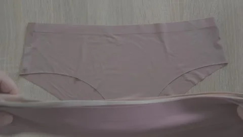Female hand testing elasticity seamless panties, Woman choosing delicate un.. Stock Footage 335085646