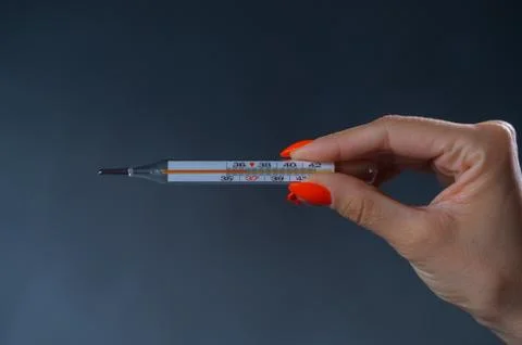 Female hand with a thermometer with a normal temperature. Stock Illustration