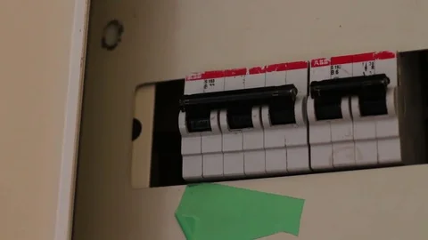 Female hand toggle switch in the switch box, All switches being turned on and Stock Footage 78767370