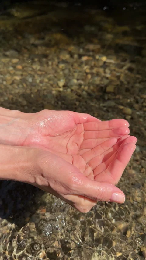 Female hand touching the clear river water Stock Footage 316527413