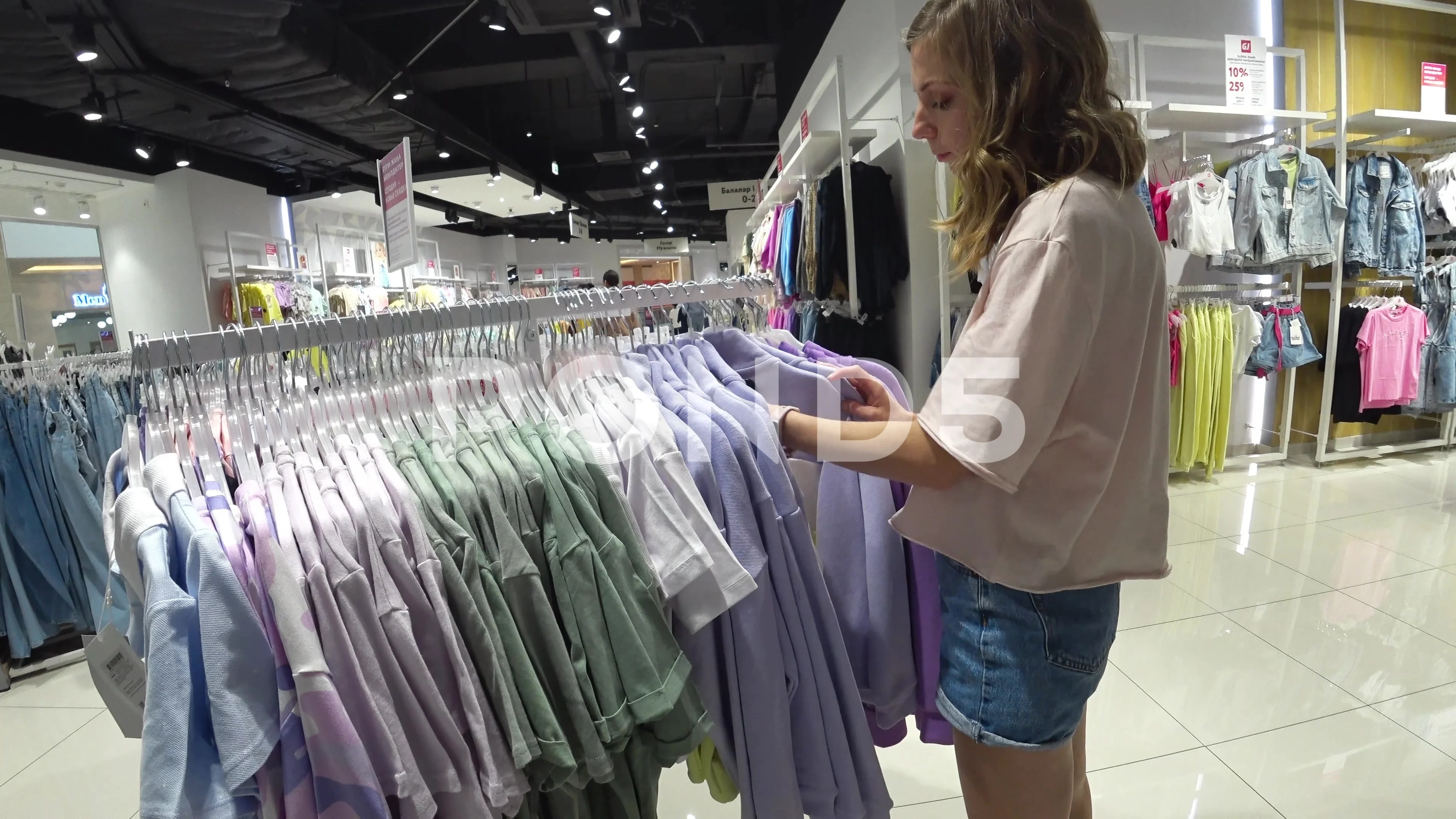 female hand touching clothes in a clothi, Stock Video