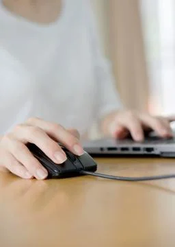 Female hand touching computer mouse closeup Stock Photos