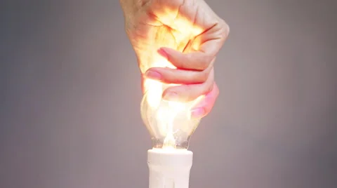 Female hand twists bulb in a cartridge Stock Footage 59643459