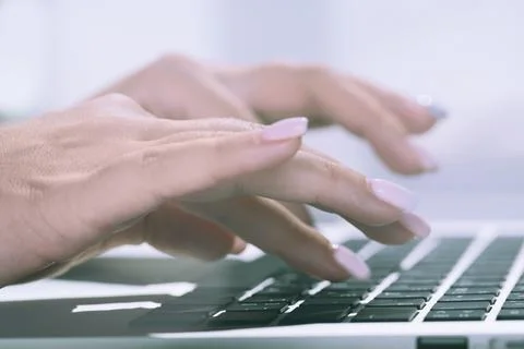 Female hand typing on computer keyboard Stock Photos