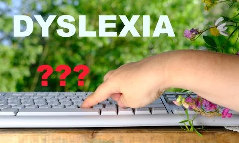 Female hand typing on computer keyboard, DYSLEXIA word, dyslexia awareness,.. Stockfoto's