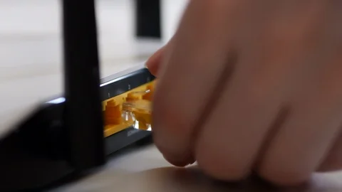 Female Hand Unplug In Ethernet Cable In WiFi Router Stock Footage 86712978