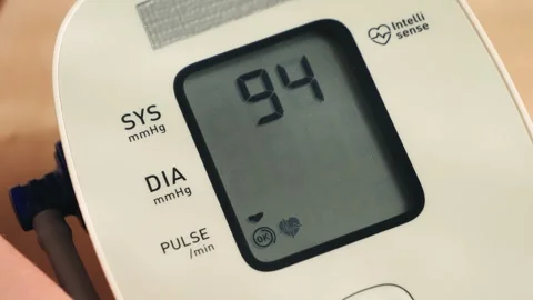 Female hand using automatic tonometer for blood pressure checking. Stock Footage 326311960