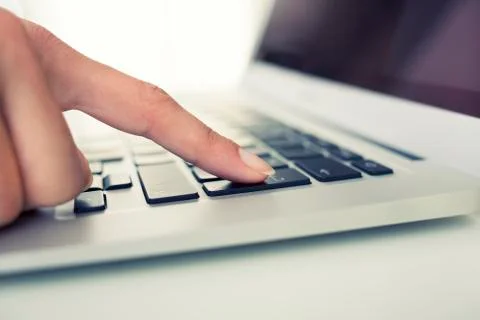 Female hand using computer keyboard, enter  button Stock Photos