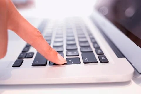 Female hand using computer keyboard, enter button Stock Photos