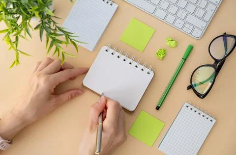 Female hand using Computer keyboard online working at home on yellow backgrou 库存照片