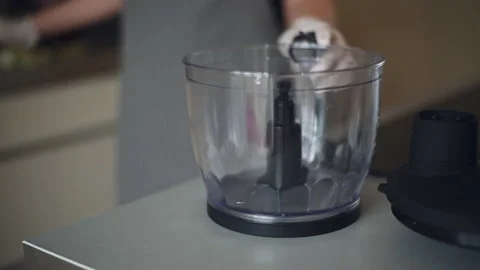 Female hand using kitchen unit putting onion inside closeup Stock Footage 132297126