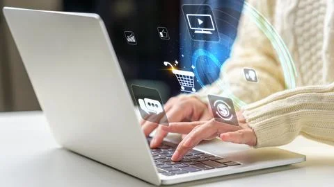 Female hand using a laptop with floating digital e-commerce and communicati.. Stock Photos