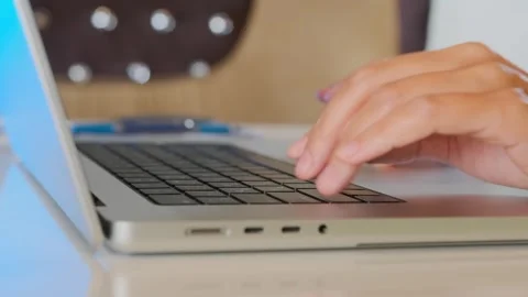 Female hand using laptop touchpad in close-up, navigating interface and browsing Stock Footage 333768032