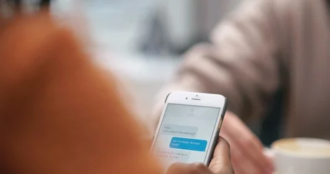 Female hand using phone for sending and receiving text messages in chat Stock Footage 99320985