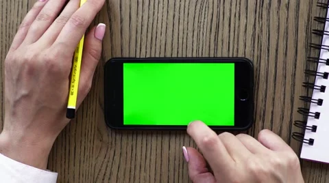 Female hand using smart phone or cellphone with pencil and recycle notebook Stock Footage 67648528