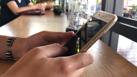 A female hand using smartphone in coffee shop. Stock Footage 86608395
