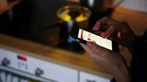 Female hand using smartphone in kitchen, handheld shot 스톡 동영상 59825000